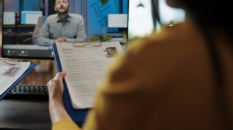 Businesswoman reading freelancer cv discussing hiring offer with remote recruiter during online videocall meeting conference in startup company office. Teleconference call on computer screen